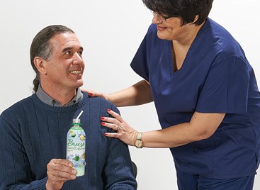 patient holding Breeza bottle